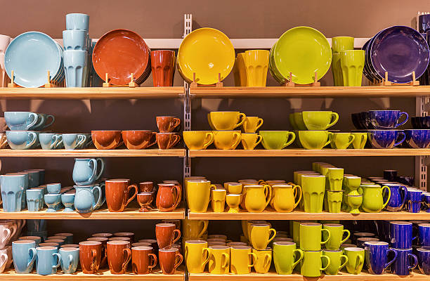 retail display of multicolored porcelain dishes and mugs on the shelves.